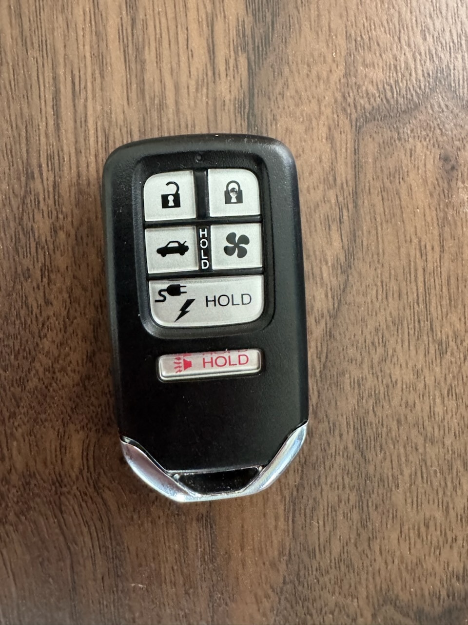 Close-up photos of intact Honda and Nissan vehicle remote key fobs, including a blue-and-black Honda Driver 2 fob and a Nissan remote. - view 2