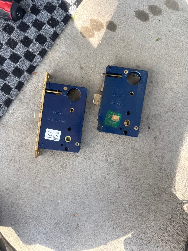 Brass keyed lock, knob, and mortise-style edge hardware on an older residential door in Denver - view 3