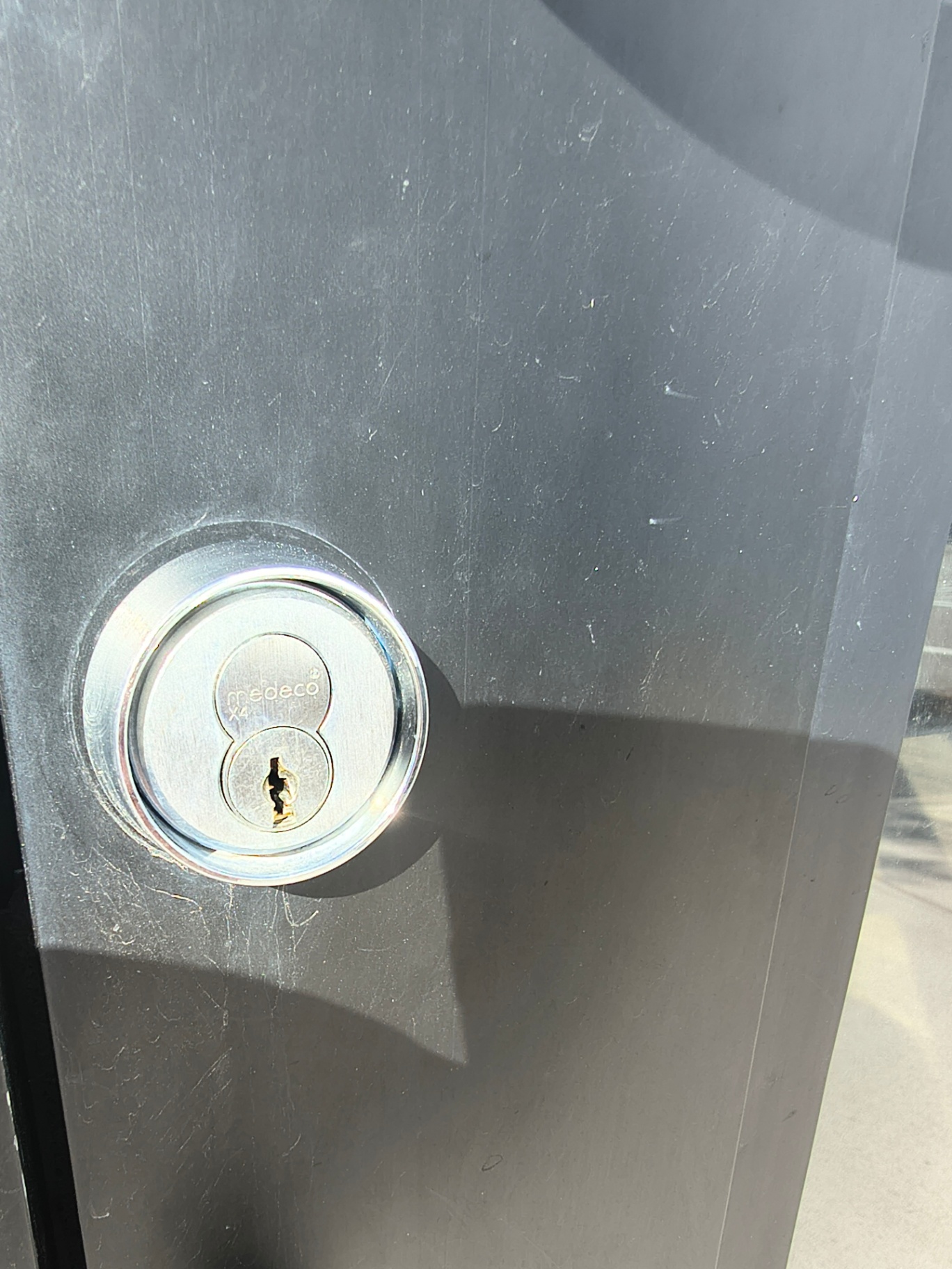 Black-framed commercial glass entrance in Arvada with pull handles and visible keyed lock cylinders - view 6