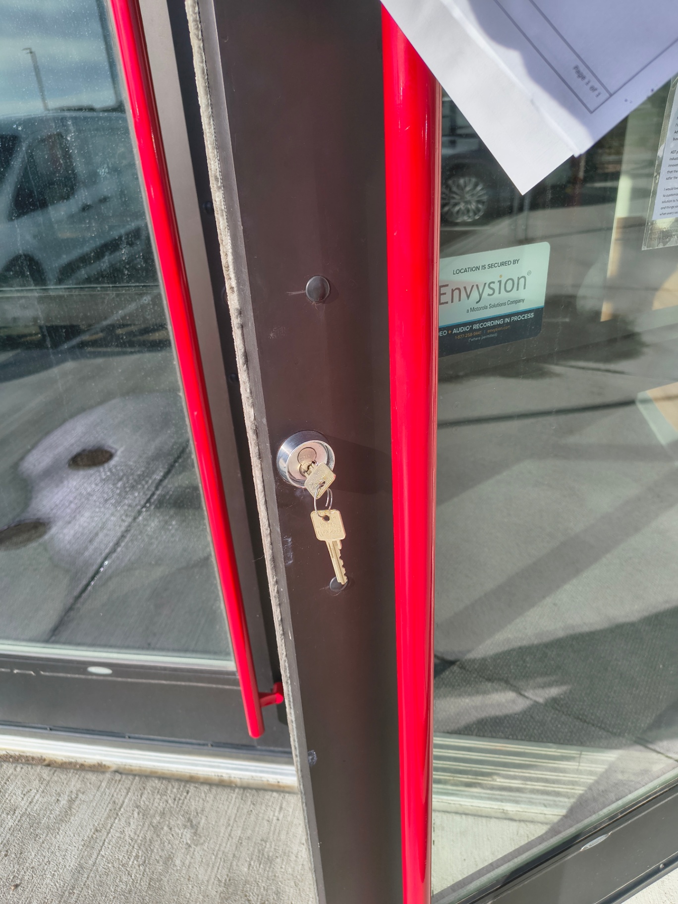 Black-framed commercial glass entrance in Arvada with pull handles and visible keyed lock cylinders - view 5