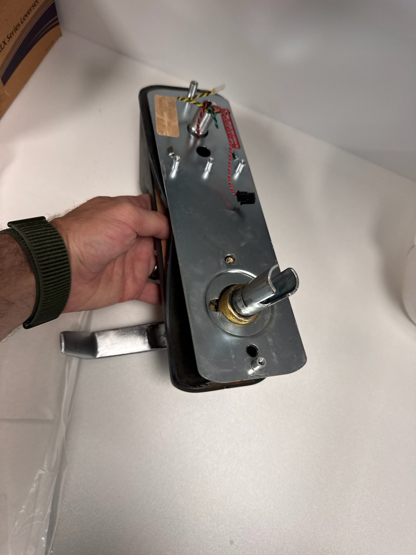 Commercial metal door with a silver numeric keypad lock, key cylinder, lever handle, rust, and exposed mounting holes. - view 5
