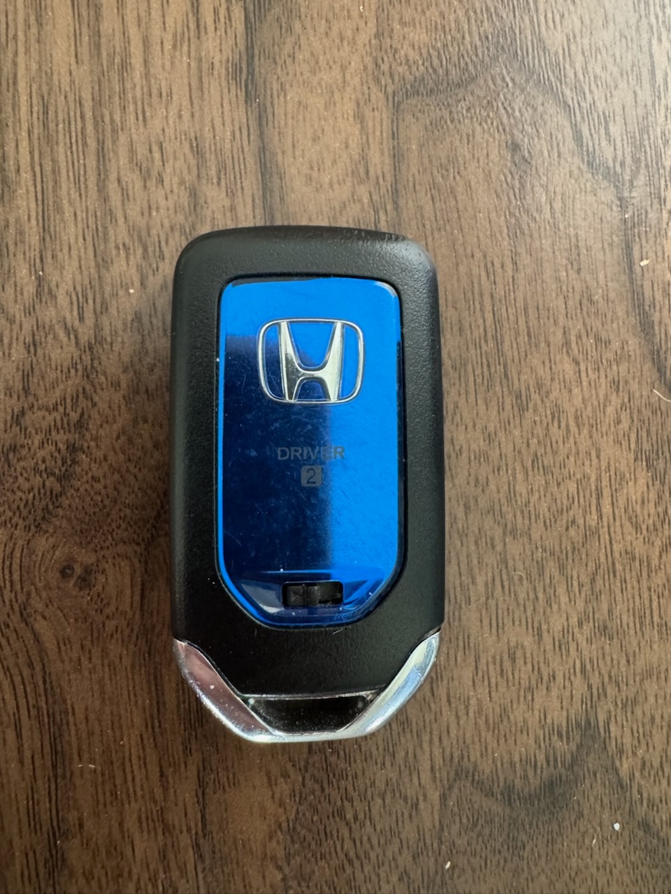 Close-up photos of intact Honda and Nissan vehicle remote key fobs, including a blue-and-black Honda Driver 2 fob and a Nissan remote.