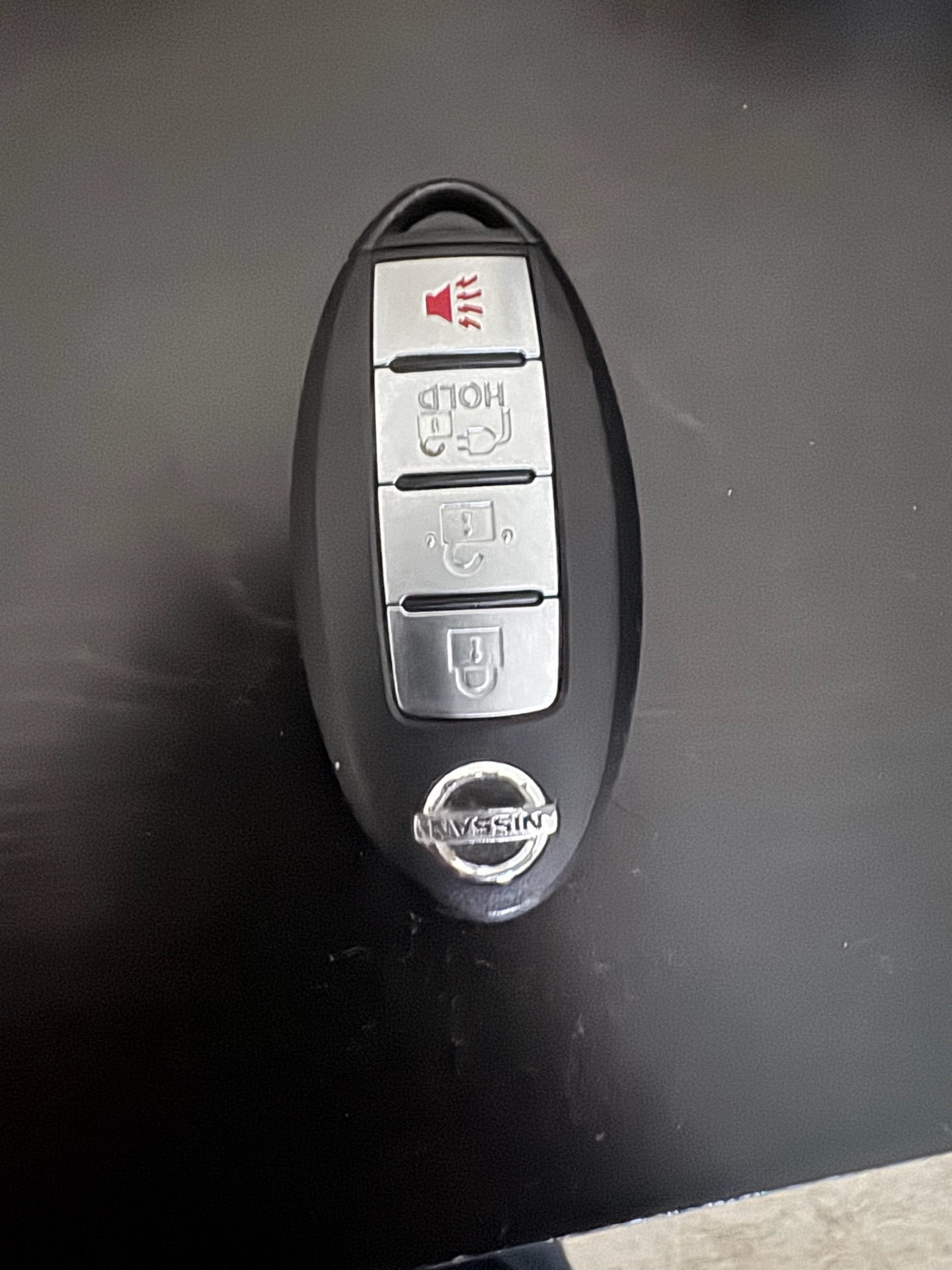 Close-up photos of intact Honda and Nissan vehicle remote key fobs, including a blue-and-black Honda Driver 2 fob and a Nissan remote. - view 4